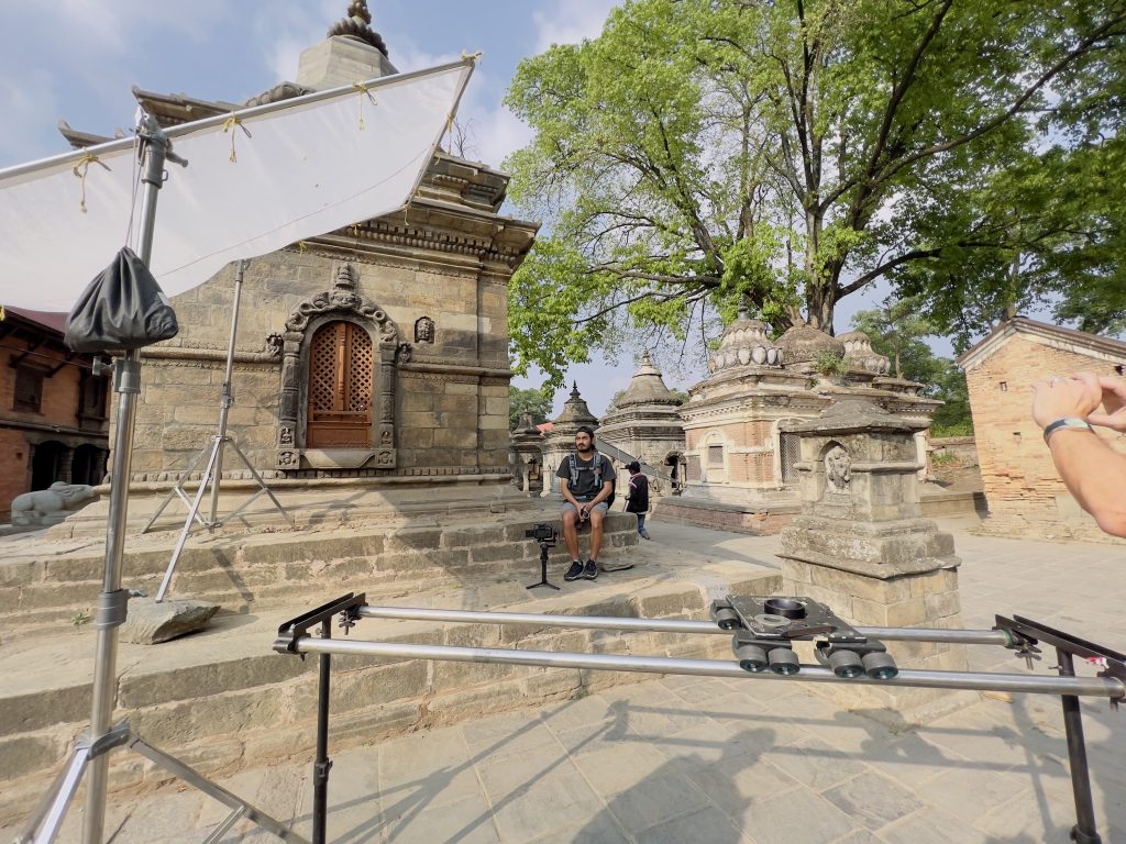 Camera dolly track and a reflector set up on the stone steps of a temple complex in Nepal